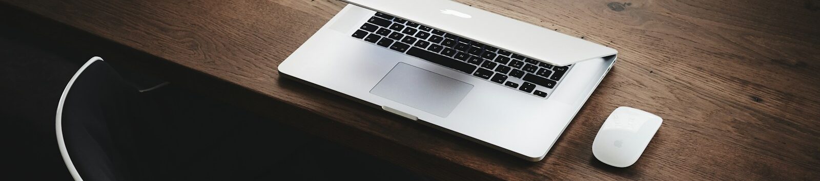 Apple MacBook beside computer mouse on table